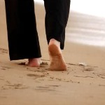 Woman walking on sandbeach in the caribbean